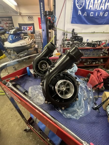 Watercraft engine components on a shop cart