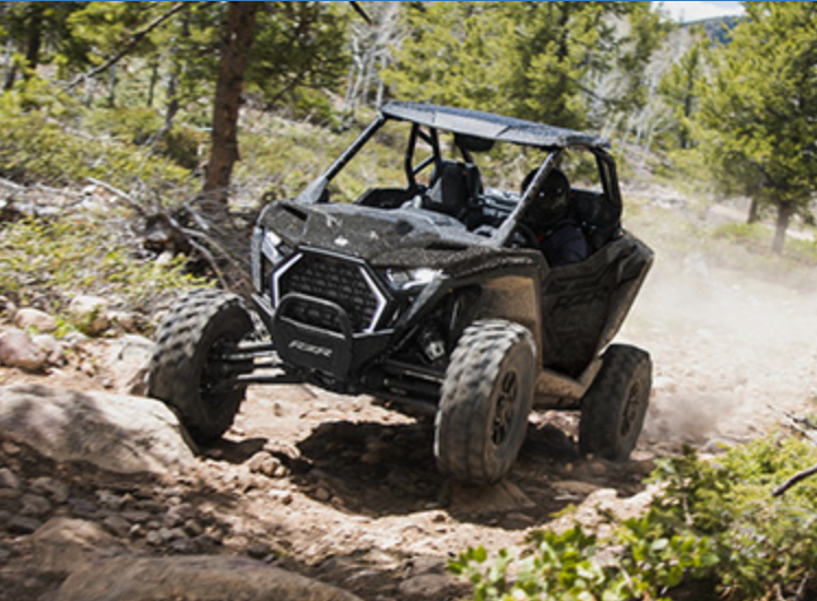 Side-by-side vehicle on a rocky wooded trail