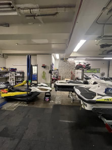 Personal watercraft on lifts inside the Lake Hopatcong Motorsports workshop